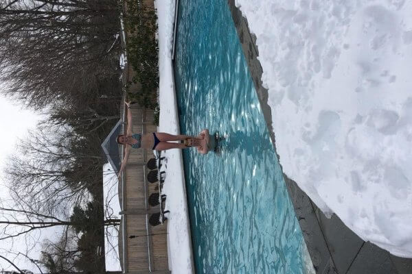 Family Playing In Heated Outdoor Swimming Pool