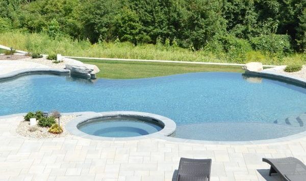 Aqua Pool & Patio gunite swimming pool construction in Connecticut showing large custom swimming pool with expansive patio