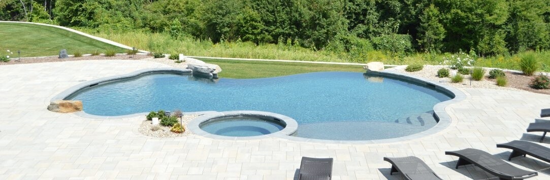 Aqua Pool & Patio gunite swimming pool construction in Connecticut showing large custom swimming pool with expansive patio