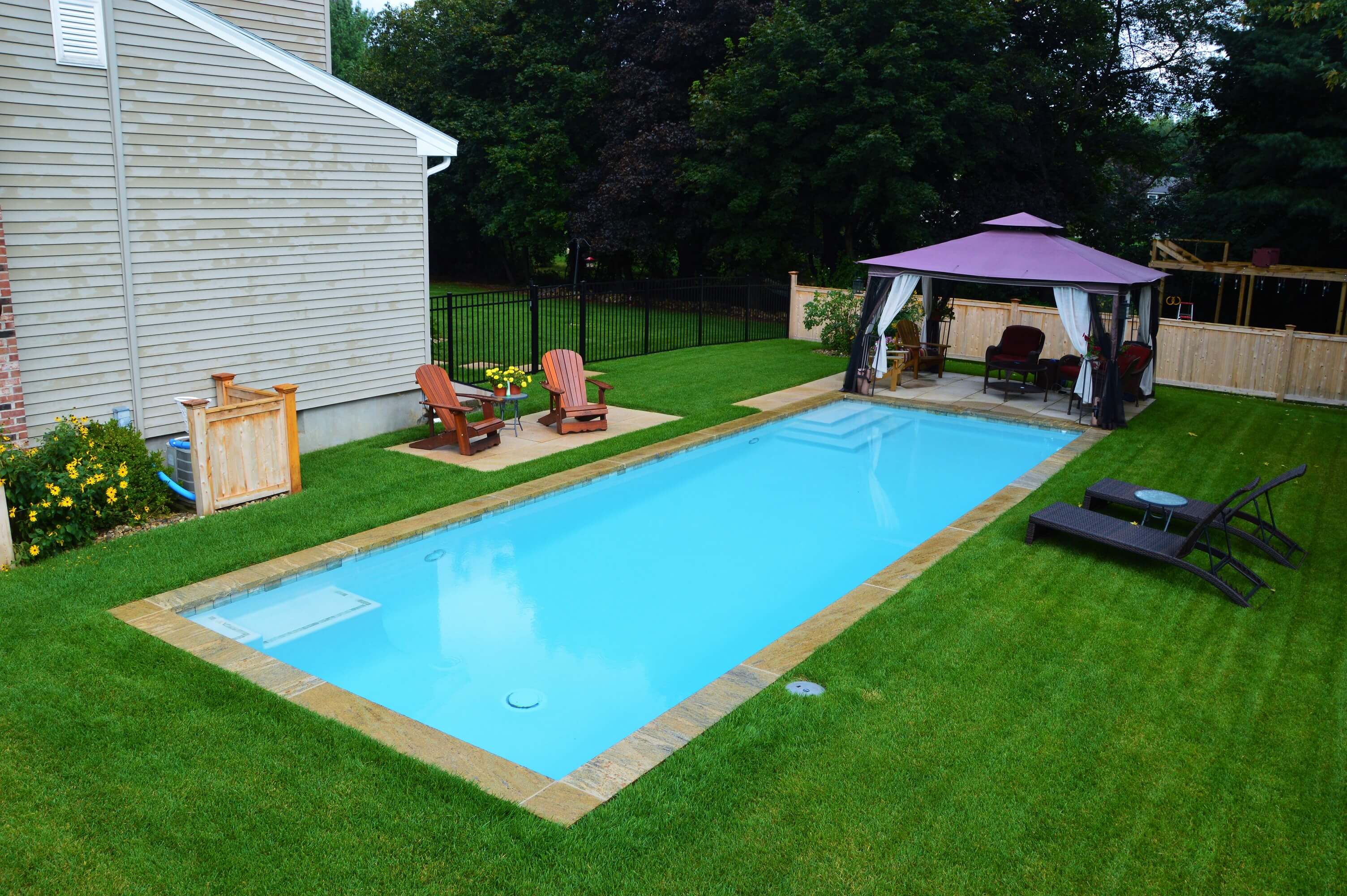 Aqua Pool & Patio gunite swimming pool construction in Connecticut showing geometric pool wtih seating