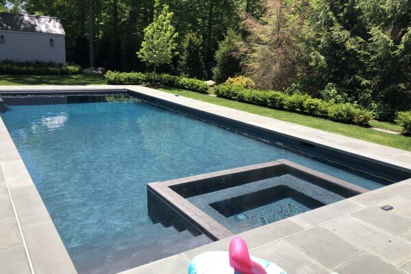 Aqua Pool & Patio gunite swimming pool construction in Connecticut showing geometric pool with hot tub