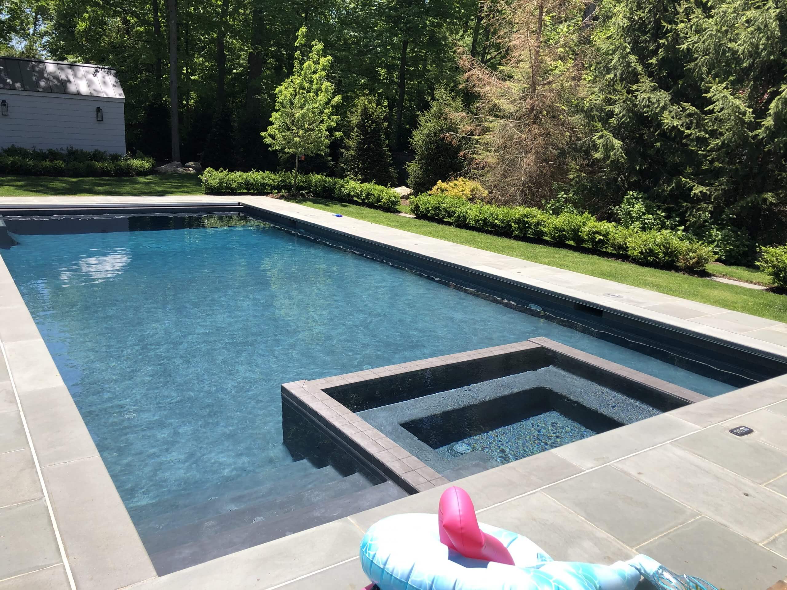 Aqua Pool & Patio gunite swimming pool construction in Connecticut showing geometric pool with hot tub