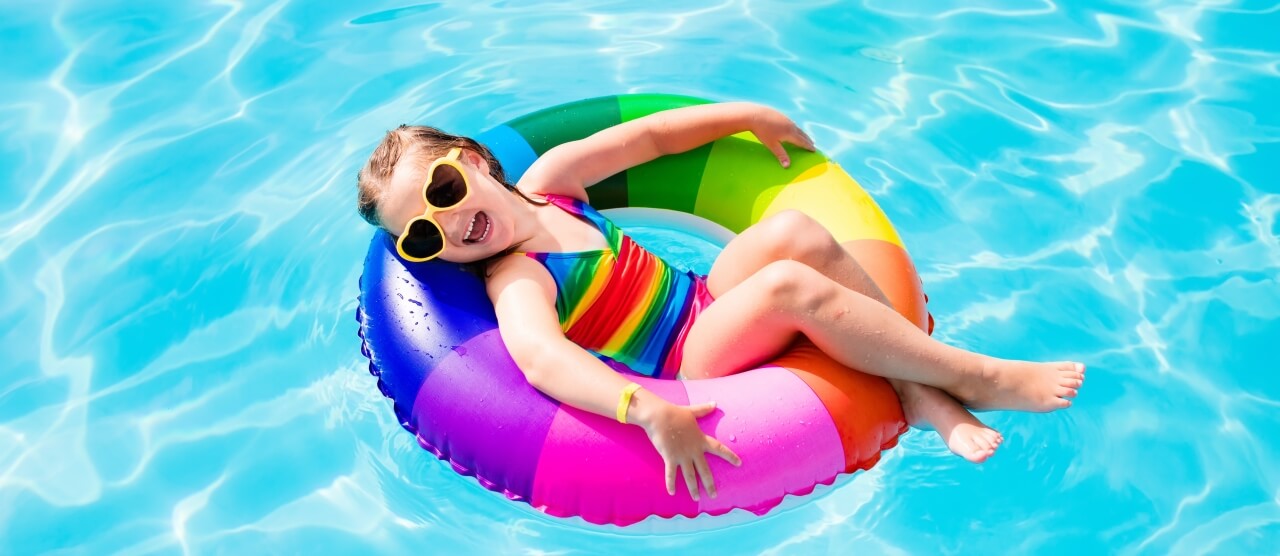 Aqua Pool & Patio gunite swimming pool construction in Connecticut showing kid floating in tube in pool