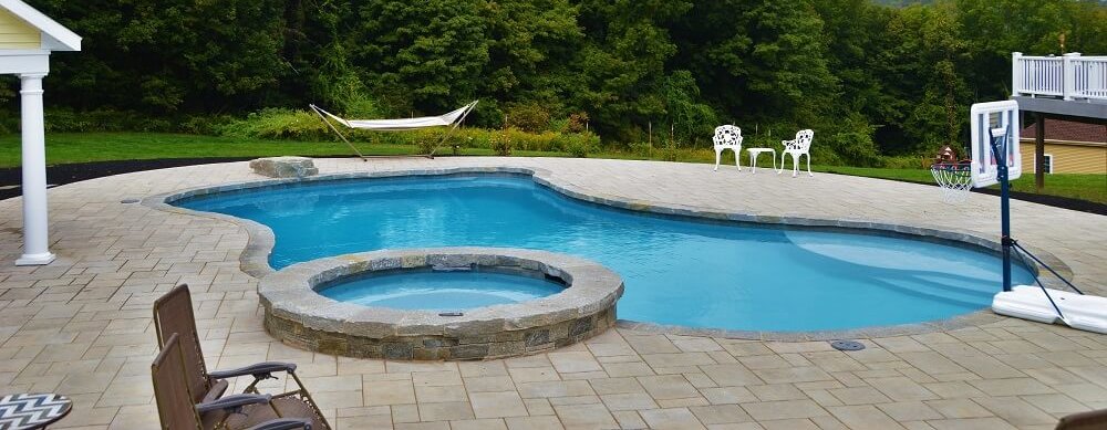 Aqua Pool & Patio gunite swimming pool construction in Connecticut showing freeform pool with hottub