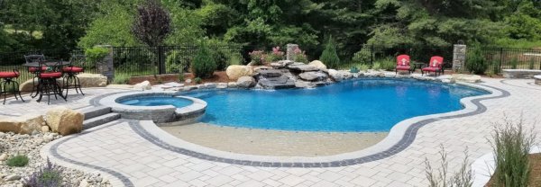 Aqua Pool & Patio gunite swimming pool construction in Connecticut showing free form pool with hot tub and waterfall