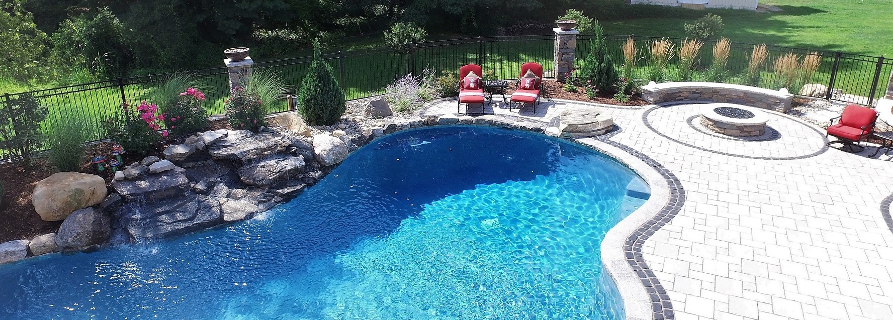 Aqua Pool & Patio gunite swimming pool construction in Connecticut showing pool with patio and seating area