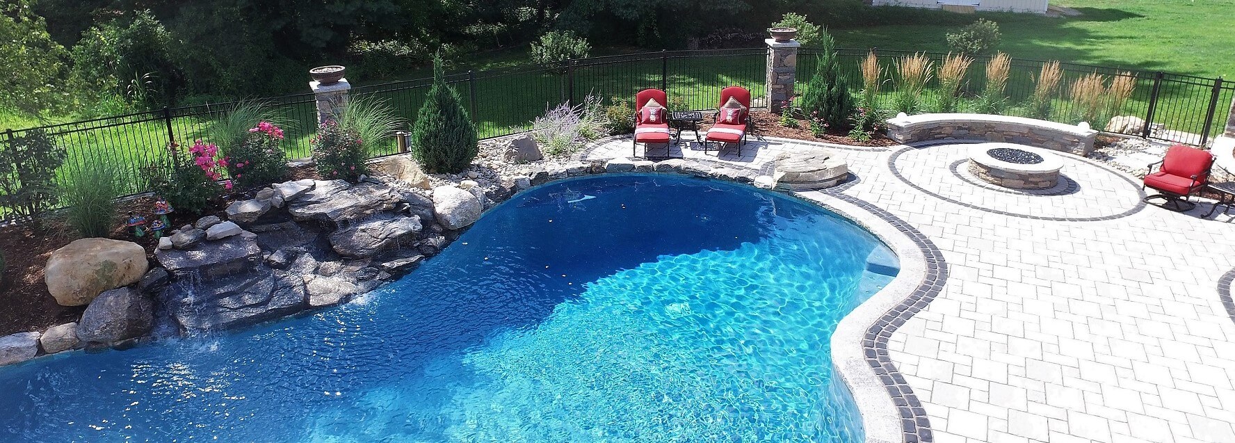 Aqua Pool & Patio gunite swimming pool construction in Connecticut showing pool with patio and seating area