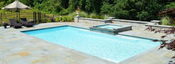 Aqua Pool & Patio gunite swimming pool construction in Connecticut showing swimming pool with attached spa and patio