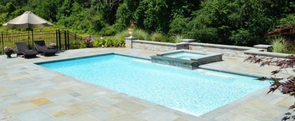 Aqua Pool & Patio gunite swimming pool construction in Connecticut showing swimming pool with attached spa and patio