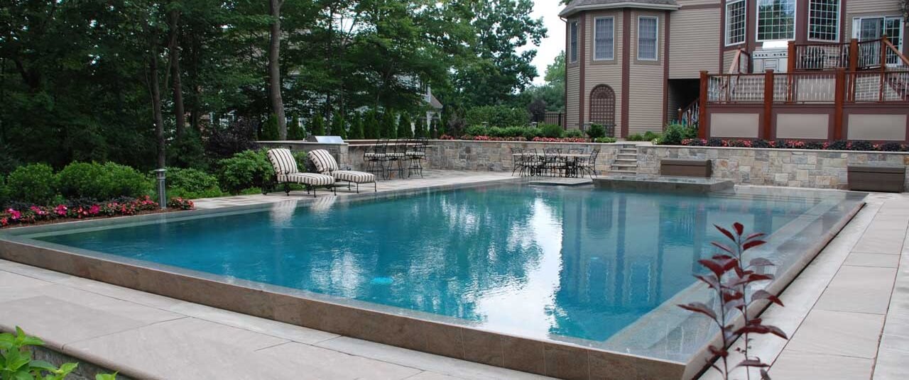 Aqua Pool & Patio gunite swimming pool construction in Connecticut showing geometric pool near home