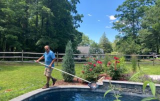 Aqua Pool & Patio gunite swimming pool construction in Connecticut showing pool cleaning