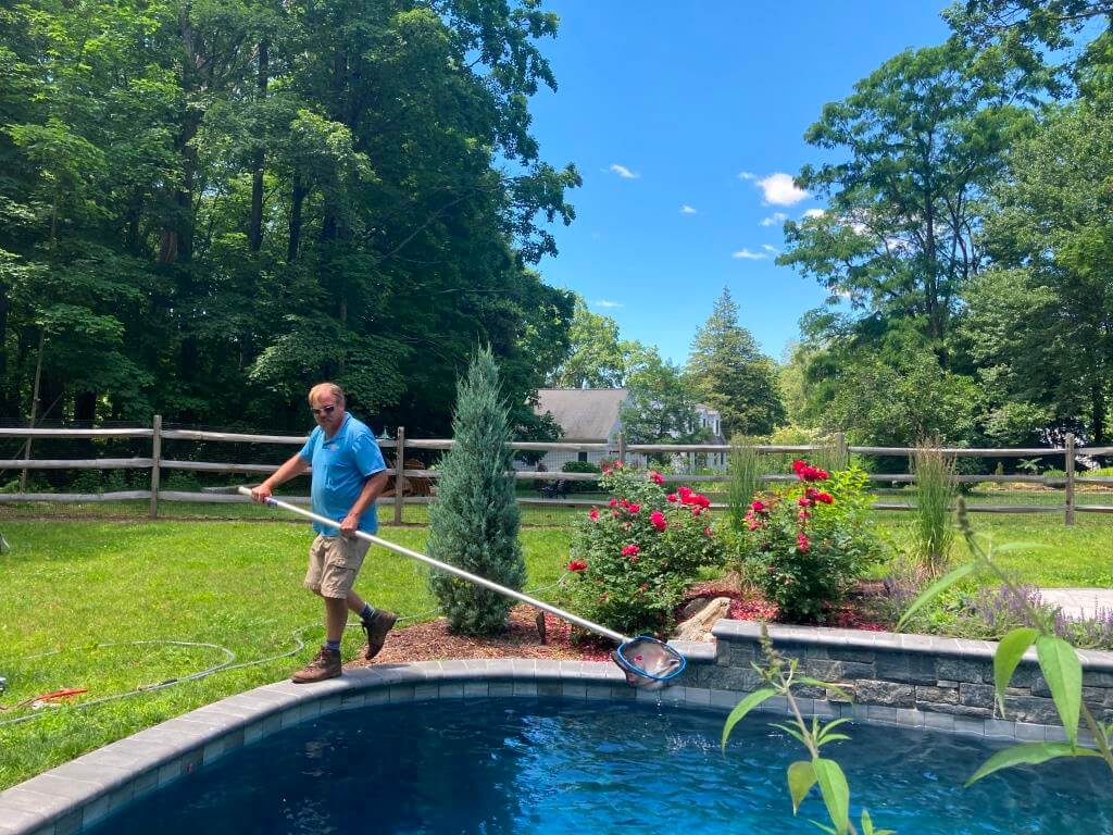 Aqua Pool & Patio gunite swimming pool construction in Connecticut showing pool cleaning