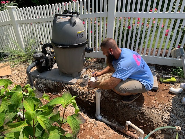 Aqua Pool & Patio gunite swimming pool construction in Connecticut showing crew plumbing pool