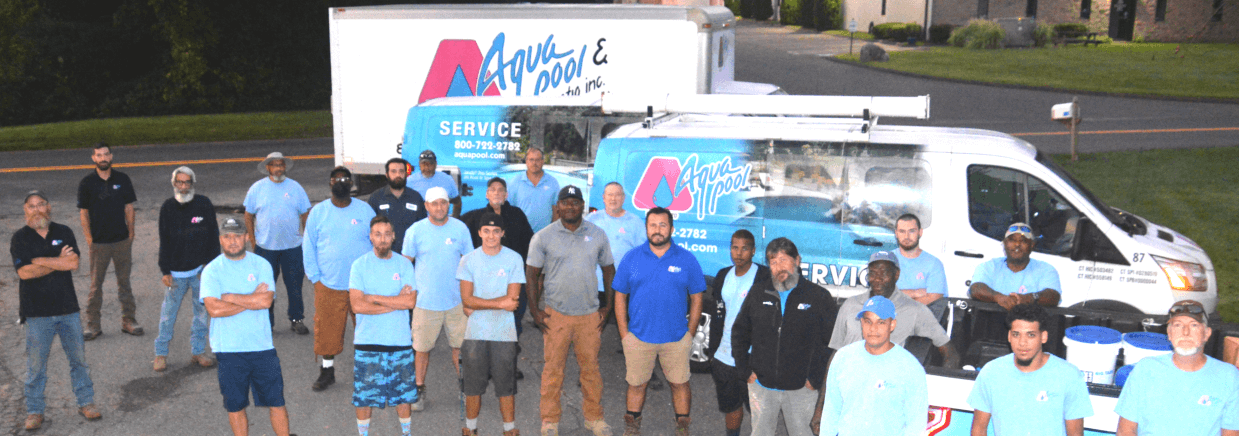 Aqua Pool & Patio gunite swimming pool construction in Connecticut showing our crew and team in front of our vans