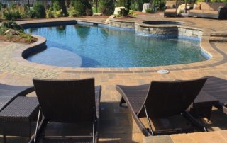 Aqua Pool & Patio gunite swimming pool construction in Connecticut showing freeform pool and seating