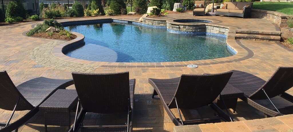 Aqua Pool & Patio gunite swimming pool construction in Connecticut showing freeform pool and seating