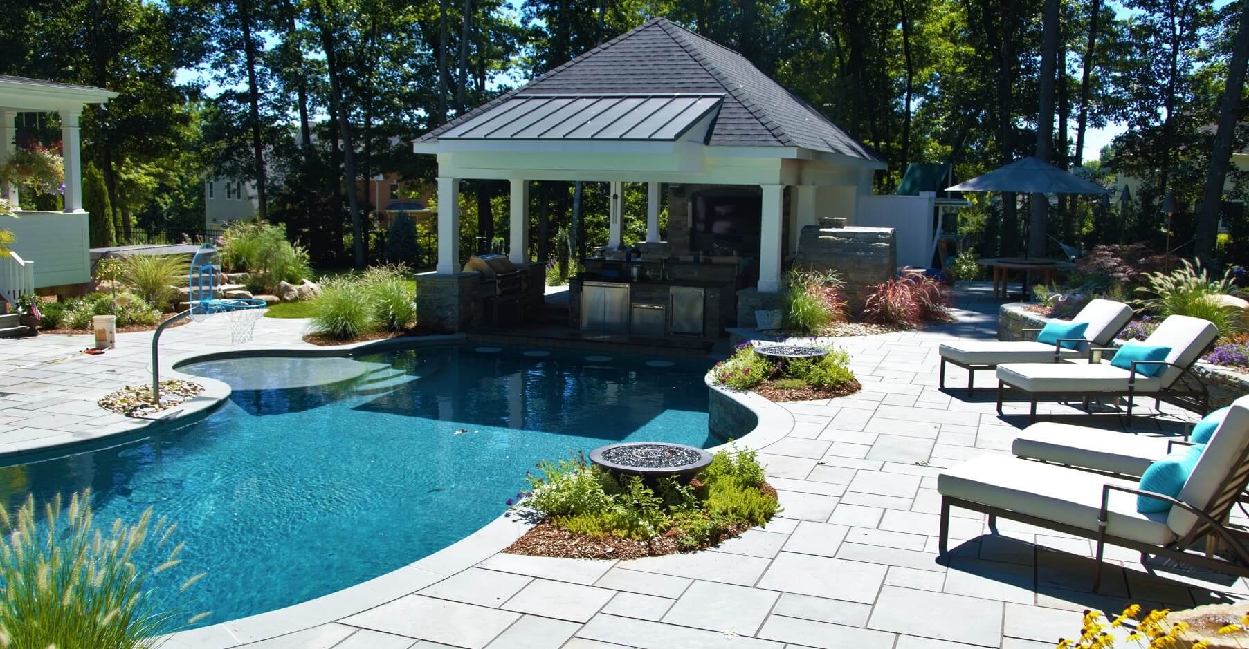 Aqua Pool & Patio gunite swimming pool construction in Connecticut showing pool with covered patio and seating