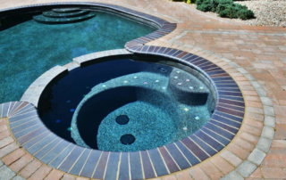 Swimming pool with attached hot tub
