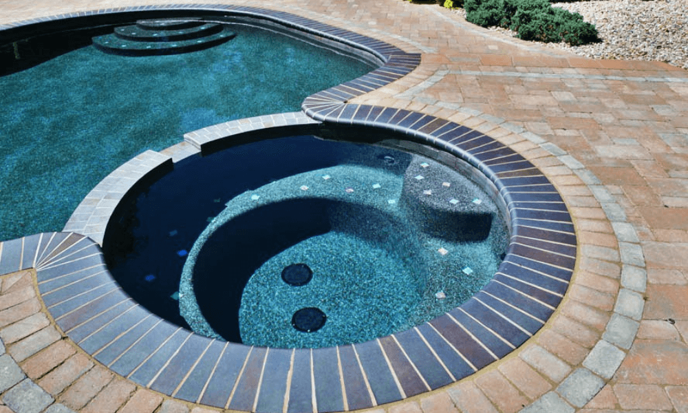 Swimming pool with attached hot tub